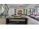 Open-concept living room with fireplace, billiards area, and water views at 5500 W Lake Butler Rd, Windermere, FL 34786