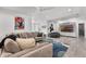 Spacious living room featuring a comfortable sofa, modern art, and stylish decor for a cozy and inviting atmosphere at 5500 W Lake Butler Rd, Windermere, FL 34786