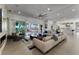 Large living room with water views, billiards area, and modern fireplace at 5500 W Lake Butler Rd, Windermere, FL 34786