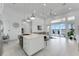 Open concept living space with modern kitchen, living room, and access to the outdoor deck with lake views at 5500 W Lake Butler Rd, Windermere, FL 34786