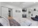 Stylish bedroom with barn door, mounted TV, and comfortable seating area at 5500 W Lake Butler Rd, Windermere, FL 34786