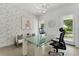 Bright home office with decorative wallpaper, glass desk, modern lighting, and view to the outside at 5500 W Lake Butler Rd, Windermere, FL 34786