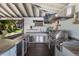 Well-equipped outdoor kitchen with grill, counter, fridge and lots of lighting at 5500 W Lake Butler Rd, Windermere, FL 34786