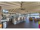 An outdoor kitchen with seating, bar, TV, and view of the water at 5500 W Lake Butler Rd, Windermere, FL 34786