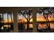 Expansive patio view with large windows offering panoramic sunset views over the lake at 5500 W Lake Butler Rd, Windermere, FL 34786