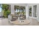 Inviting sitting area with comfortable chairs, round rug, and large windows overlooking the water at 5500 W Lake Butler Rd, Windermere, FL 34786