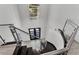 Elegant staircase with glass railings and a chandelier, creating a stunning focal point and a grand entrance at 5500 W Lake Butler Rd, Windermere, FL 34786