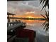 Stunning sunset view from the dock featuring comfortable seating and serene water reflections at 5500 W Lake Butler Rd, Windermere, FL 34786