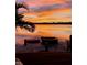 Inviting waterfront area with a fire pit, seating, and stunning sunset views at 5500 W Lake Butler Rd, Windermere, FL 34786
