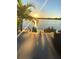 Beautiful waterfront view at sunset with a seating area and palm trees creating a relaxing atmosphere at 5500 W Lake Butler Rd, Windermere, FL 34786