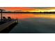 Breathtaking sunset over the water viewed from a private dock with lounge chairs, offering serene relaxation at 5500 W Lake Butler Rd, Windermere, FL 34786