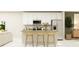 A well-lit kitchen showcasing white cabinetry, stainless steel appliances, and a stylish island with seating at 7314 Ivy Tendril Ave, Orlando, FL 32829