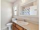 Well-lit bathroom featuring a vanity with a sink, toilet, mirror, and shower-tub combination at 7759 Sugar Bend Dr # 7759, Orlando, FL 32819