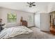 Comfortable primary bedroom featuring two windows, neutral walls, and a ceiling fan at 7759 Sugar Bend Dr # 7759, Orlando, FL 32819