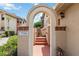 Charming townhome entrance featuring an arched doorway, steps, and warm exterior paint at 7759 Sugar Bend Dr # 7759, Orlando, FL 32819