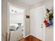 Inviting entryway features hardwood floors, leading to a bedroom view, and a collection of hats on the wall at 7759 Sugar Bend Dr # 7759, Orlando, FL 32819