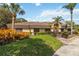 Well-maintained home features a lush front yard with palm trees and manicured landscaping at 7759 Sugar Bend Dr # 7759, Orlando, FL 32819