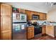Kitchen with stainless steel fridge, granite countertops, and warm wood cabinets at 7759 Sugar Bend Dr # 7759, Orlando, FL 32819