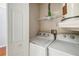 Functional laundry room with a side-by-side washer and dryer, and shelving at 7759 Sugar Bend Dr # 7759, Orlando, FL 32819