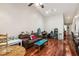 Open living area features hardwood floors, a vaulted ceiling, and comfortable seating at 7759 Sugar Bend Dr # 7759, Orlando, FL 32819