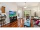Bright living room features hardwood floors, a ceiling fan, and sliding glass doors to the balcony at 7759 Sugar Bend Dr # 7759, Orlando, FL 32819