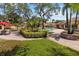 Community pool area surrounded by mature palm trees, lush landscape, and lounge chairs at 7759 Sugar Bend Dr # 7759, Orlando, FL 32819