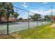 Fenced community tennis court for residents, surrounded by lush landscaping and offering a recreational amenity at 7759 Sugar Bend Dr # 7759, Orlando, FL 32819