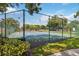 View of well maintained tennis courts, surrounded by a secure chain-link fence at 7759 Sugar Bend Dr # 7759, Orlando, FL 32819