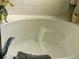 Clean white bathtub in a bathroom with white tiled walls and decorative accents at 1030 Marcello Blvd, Kissimmee, FL 34746