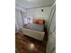 Cozy bedroom with hardwood floors, a bed with grey linens, and ample closet space at 1030 Marcello Blvd, Kissimmee, FL 34746