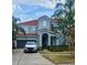Charming two-story home with a well-manicured lawn and a driveway leading to an attached garage at 1030 Marcello Blvd, Kissimmee, FL 34746