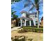 Beautiful two-story home featuring a landscaped yard, arched entryway and a side entry garage at 1030 Marcello Blvd, Kissimmee, FL 34746
