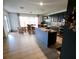 Open-concept kitchen and dining area featuring an island and dining table with chairs at 1030 Marcello Blvd, Kissimmee, FL 34746