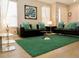 Comfortable living room with couches, large windows, and a glass coffee table on a plush rug at 1030 Marcello Blvd, Kissimmee, FL 34746
