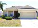 Charming single-story home with a two-car garage and well-maintained lawn and neutral exterior at 1886 Van Gogh Dr, Auburndale, FL 33823
