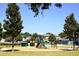 Community playground with green and brown climbing and sliding structures at 1886 Van Gogh Dr, Auburndale, FL 33823