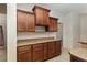 Kitchen with wooden cabinets, neutral countertops, and tile flooring at 5060 Se 40Th St, Ocala, FL 34480