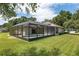 Backyard with an inviting screened-in pool, lush grass and plenty of room for outdoor enjoyment at 5060 Se 40Th St, Ocala, FL 34480