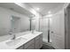 Bright bathroom featuring double sinks, a shower, and modern fixtures at 563 Bay Leaf Dr, Poinciana, FL 34759