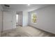 Well-lit bedroom with neutral carpet, window, and access to an en-suite bathroom at 563 Bay Leaf Dr, Poinciana, FL 34759