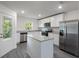 Bright and modern kitchen with stainless steel appliances, granite countertops, and island at 563 Bay Leaf Dr, Poinciana, FL 34759
