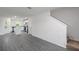 Open floor plan with gray wood-look flooring connects living area to modern kitchen at 563 Bay Leaf Dr, Poinciana, FL 34759