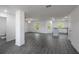 Spacious living area with gray wood-look flooring, ample natural light, and open layout at 563 Bay Leaf Dr, Poinciana, FL 34759