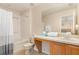 Bathroom featuring a combined shower and bathtub, vanity, and a large mirror at 140 Napoli Dr, Davenport, FL 33897