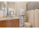 Bathroom featuring a vanity, toilet, and shower with white towels hanging on the towel rack at 140 Napoli Dr, Davenport, FL 33897