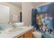 Bathroom with a single sink vanity and a shower with a decorative curtain at 140 Napoli Dr, Davenport, FL 33897