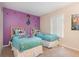 Cheerful bedroom featuring twin beds, purple walls with fun Encanto themed decor at 140 Napoli Dr, Davenport, FL 33897