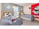 Charming bedroom with twin beds and cheerful Mickey Mouse themed decor at 140 Napoli Dr, Davenport, FL 33897