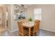 Cozy dining area with a wooden table and chairs, with a passthrough to the kitchen at 140 Napoli Dr, Davenport, FL 33897