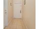 Light and airy entryway with beige tile floor and white front door at 140 Napoli Dr, Davenport, FL 33897